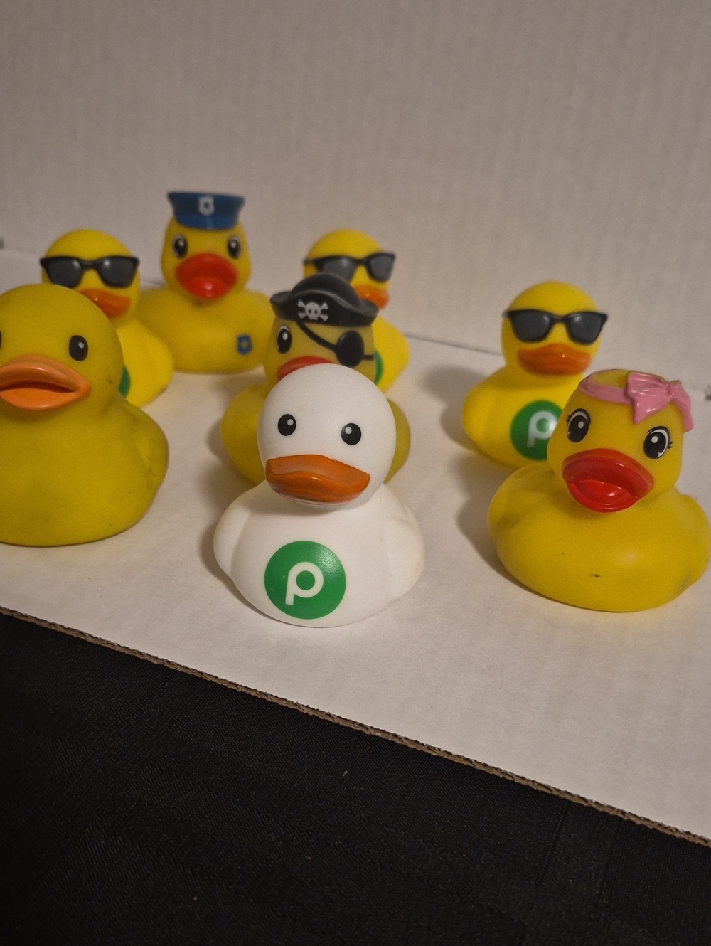 8 Rubber Duck Figures with Green 'P' Emblem. 1 White 7 Tradational Yellow